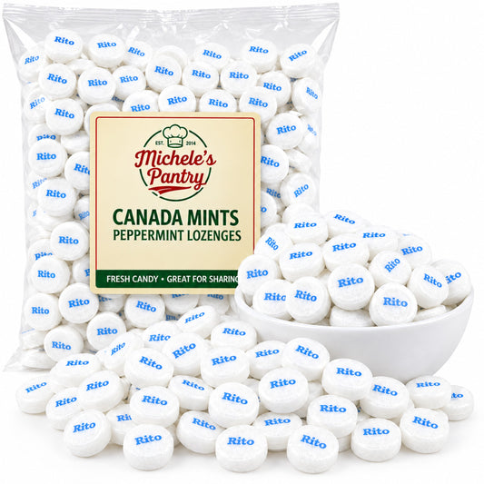 A clear plastic bag of Michele's Pantry Canada Mints Peppermint Lozenges, with white round mints printed with blue Rito logos, shown with a white bowl and scattered mints on a white background.