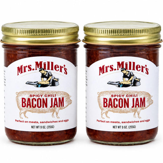 Two clear glass jars of Mrs. Miller's Maple Onion Bacon Jam with gold lids displayed side-by-side on a white background.